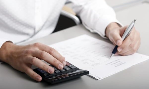 A businessman calculating expenses at tax time