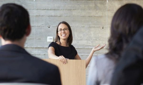 Businesswoman Delivering Presentation At Conference