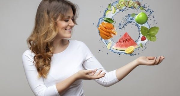 smiling woman with fruits and water splash