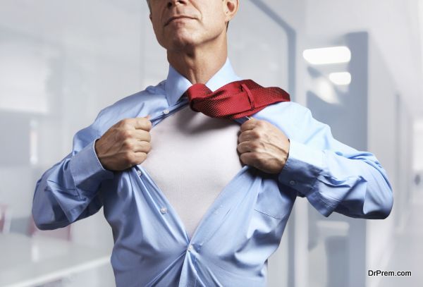 Superhero. Mature businessman tearing his shirt off over office background