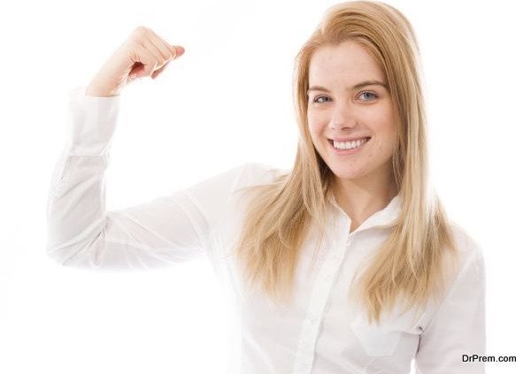 Young woman standing and flexing biceps