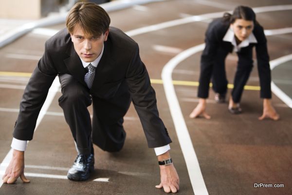 Businessman and businesswoman lined up getting ready for race in business