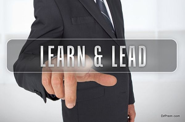 Serious businessman touching the term learn and lead