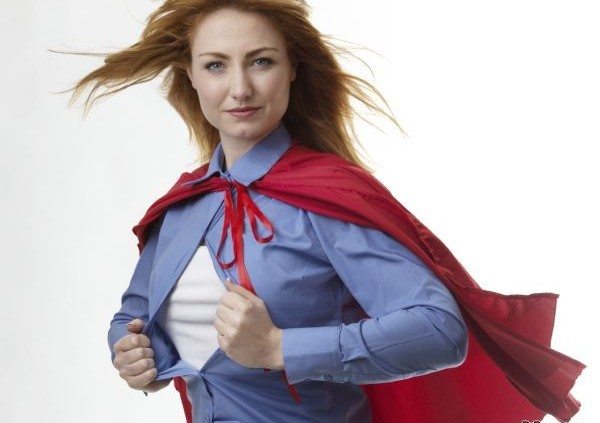 business woman wearing a super hero cape with wind in her hair