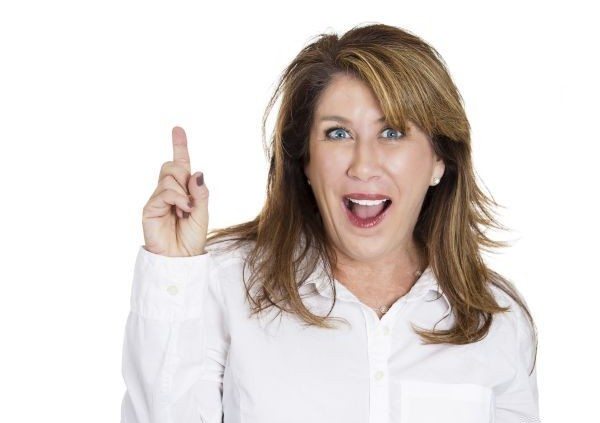 Closeup portrait intelligent excited mature woman who just came up with idea aha, pointing up, number one sign, isolated white background. Positive human emotion, facial expression feeling, attitude