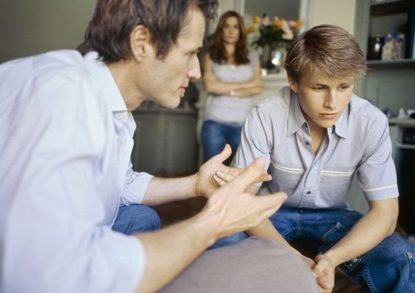 Side angle of father talking to his son