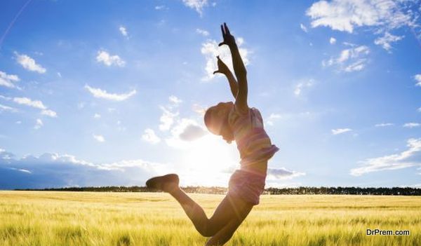 silhouette of jumping kid in the wheat field