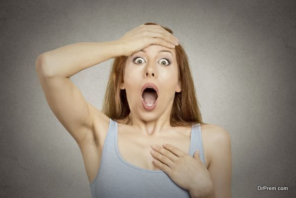 Surprise astonished woman. Closeup portrait woman looking surprised in full disbelief wide open mouth isolated grey wall background. Positive human emotion facial expression body language. Funny girl