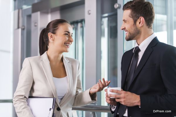 Taking time to chat with colleague. Two cheerful business people