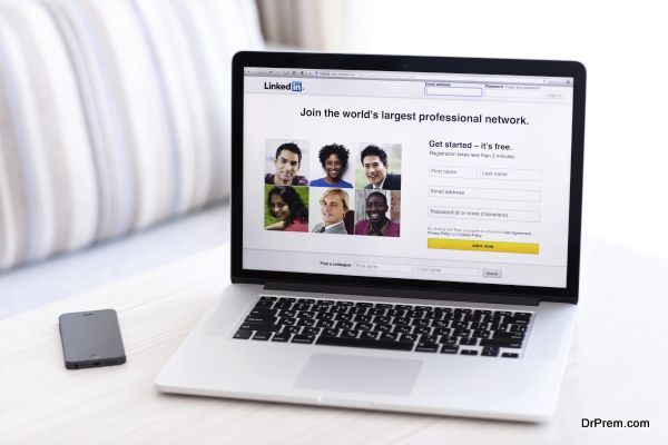 MacBook Pro Retina with LinkedIn home page on the screen stands