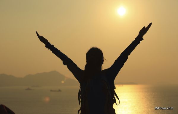 thankful hiking woman sunrise seaside