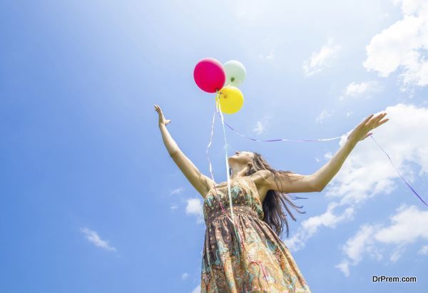 Attractive woman releasing balloons in the sky - Freedom,happiness,summer concept