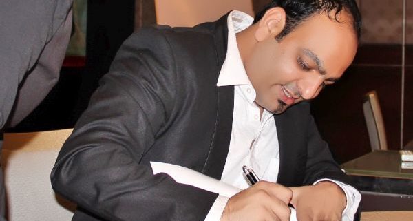 Dr Prem Signing a book