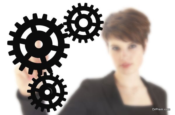 Young businesswoman with black gears isolated on white background