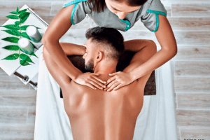 An-above-view-of-a-man-receive-a-massage-on-a-back-in-style-spa.