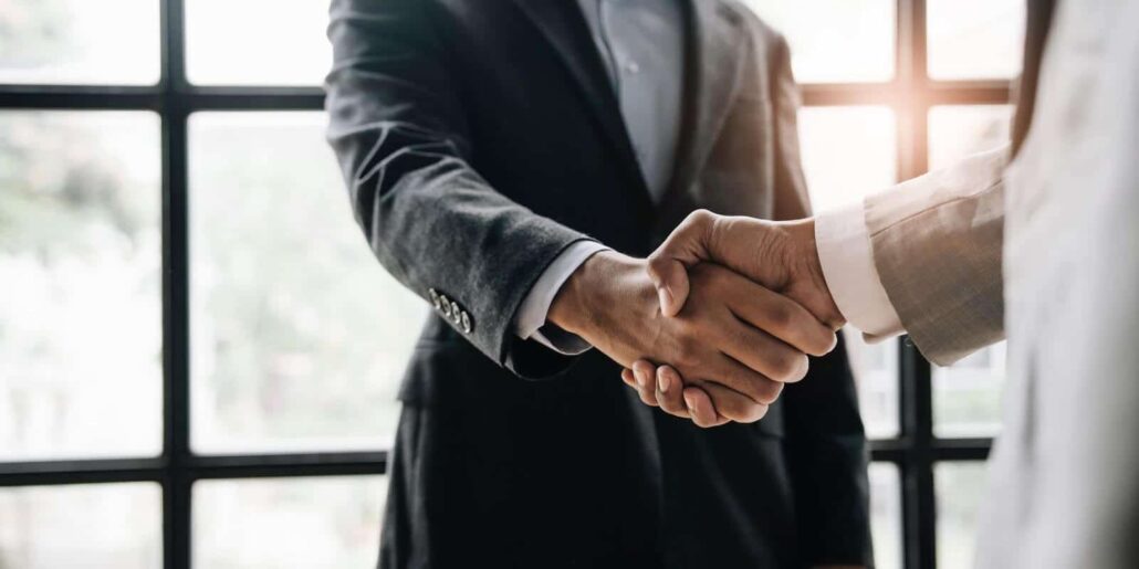 Business handshake in modern office.
