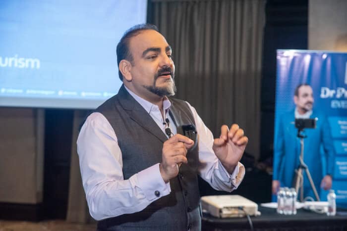 Speaker presenting at a conference.