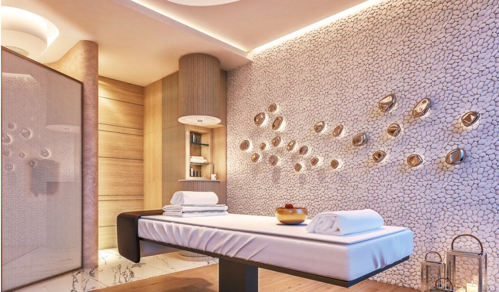 Luxury wellness spa with relaxing treatment bed, decorative wall, and ambient lighting.