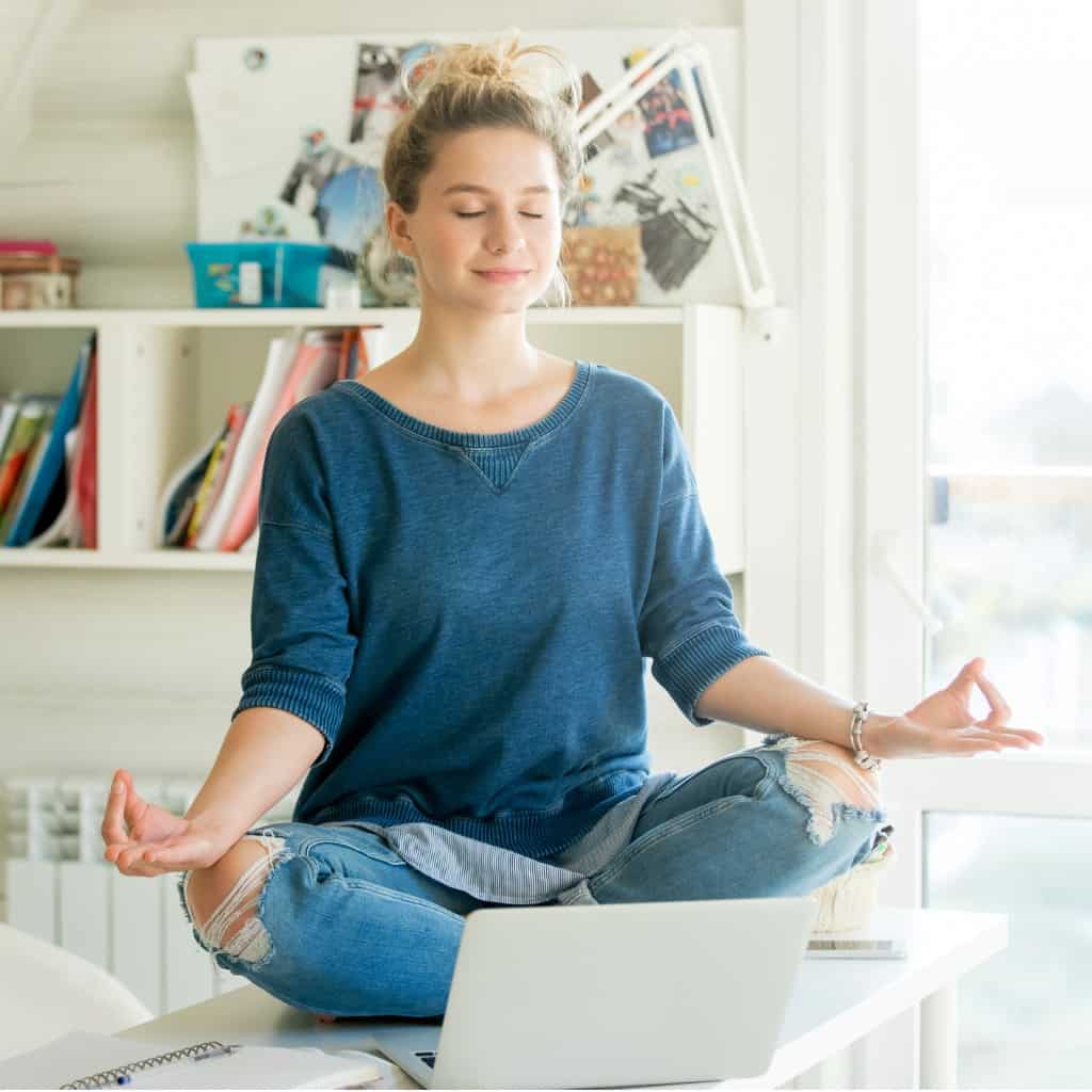 portrait-of-an-attractive-woman-at-table-lotus-pose-picture-id612737138.jpg